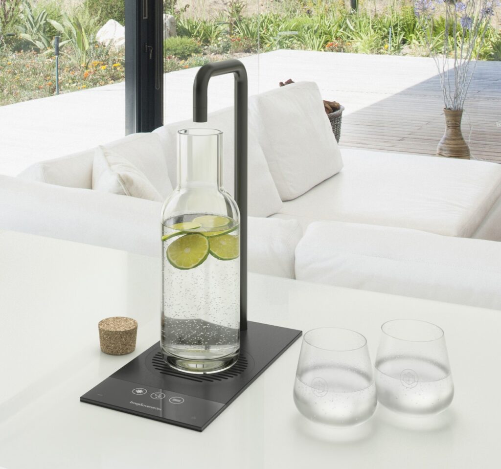 Water bottle with fruit being filled with water from black tap, with water glasses  next to it. 