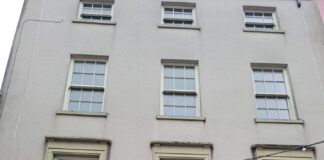 shop front showing vacant above the shop units.